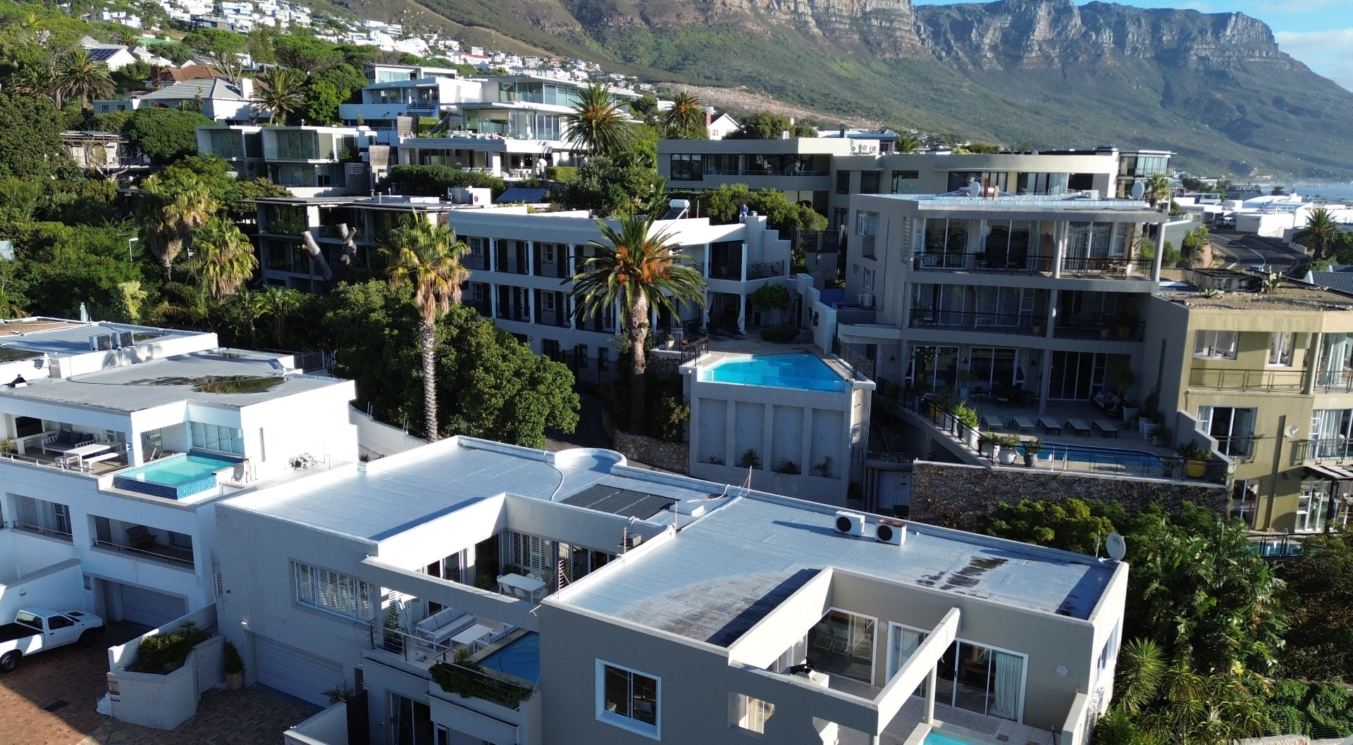 Camps Bay rooftops beneath the Twelve Apostles from the air