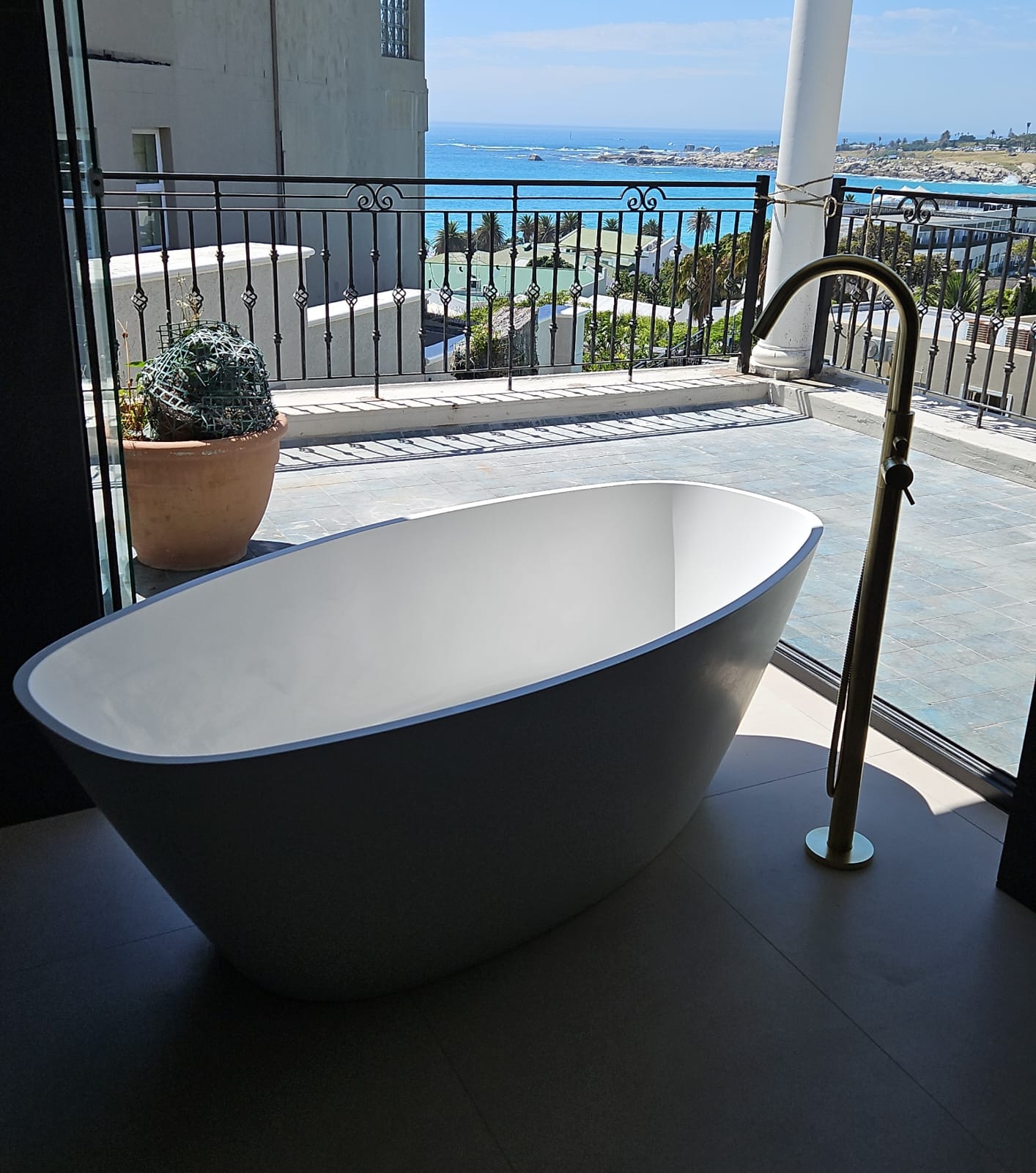 Freestanding bath at the window looking out over the Atlantic