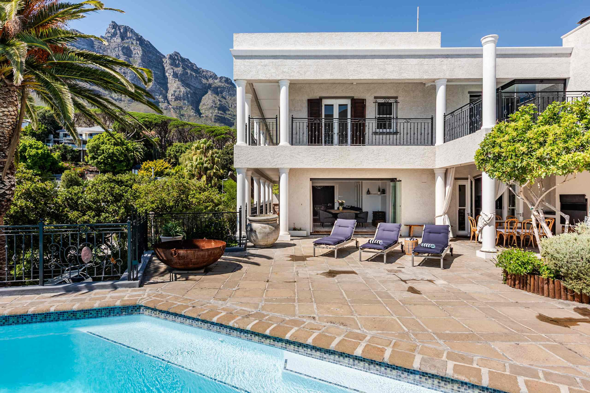 The villa and pool terrace beneath the Twelve Apostles mountains